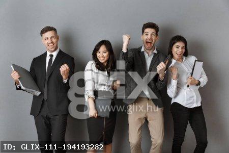 happy multicultural business people with folders and notebooks standing at grey wall