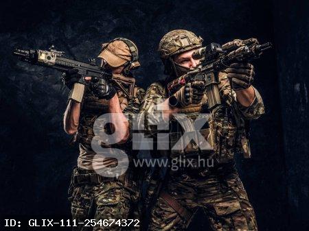 Private security service contractors, the elite special unit, full protective soldiers aiming at the targets.