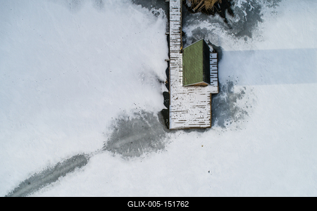 Aerial view of winter frozen lake with wooden houses on pier-stock-foto