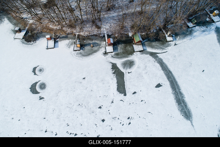 Aerial view of winter frozen lake with wooden houses on pier-stock-foto