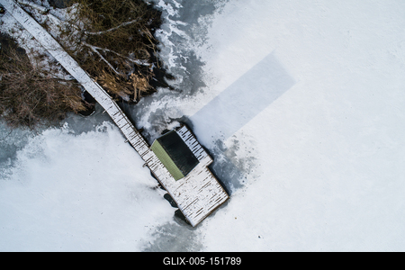 Aerial view of winter frozen lake with wooden houses on pier-stock-foto