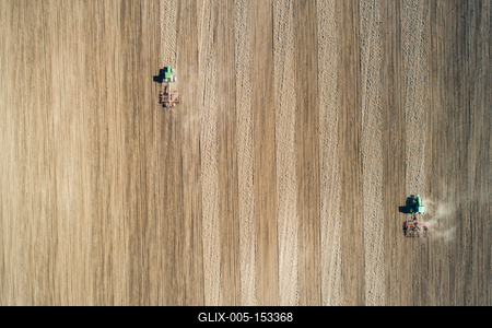 Aerial view of tractor plowing farm field in preparation for spring planting-stock-foto
