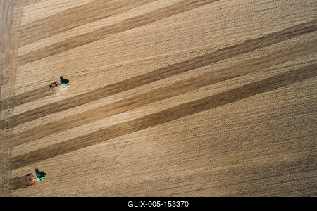 Aerial view of tractor plowing farm field in preparation for spring planting-stock-foto