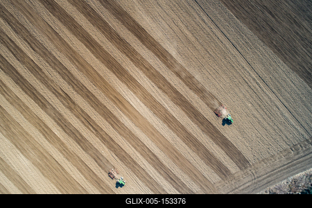 Aerial view of tractor plowing farm field in preparation for spring planting-stock-foto