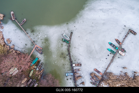Aerial view of winter frozen lake with wooden pier-stock-foto