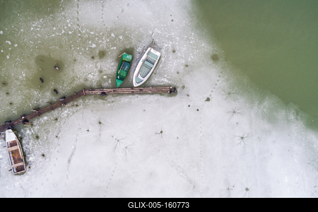 Aerial view of winter frozen lake with wooden pier-stock-foto