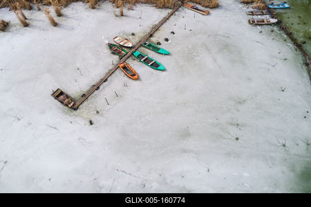 Aerial view of winter frozen lake with wooden pier-stock-foto