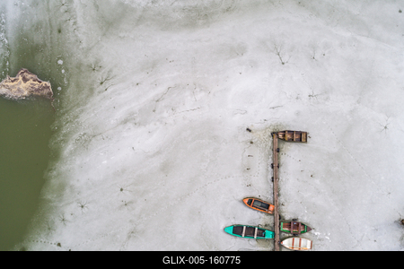 Aerial view of winter frozen lake with wooden pier-stock-foto