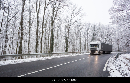 snowy road at cold wintertime with fast truck-stock-foto