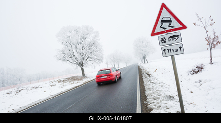 winter warning sign with snow-stock-foto
