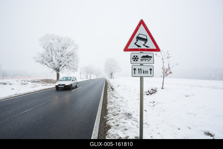 winter warning sign with snow-stock-foto
