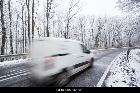fast moving van with snowy road at cold wintertime-stock-foto