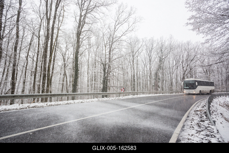 snowy road at cold wintertime with bus-stock-foto