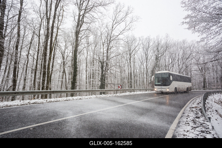 snowy road at cold wintertime with bus-stock-foto