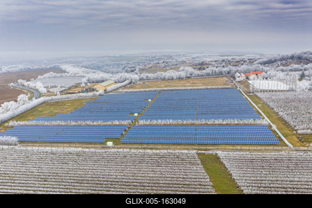 Winter frosty vineyard landscape covered by white flake with solar energy panels-stock-foto
