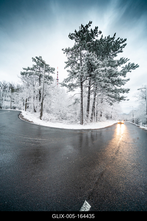Snowy road with dramatic sky-stock-foto