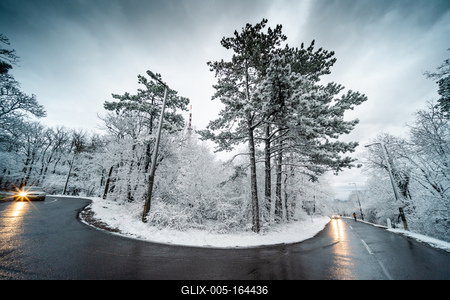 Snowy road with dramatic sky-stock-foto