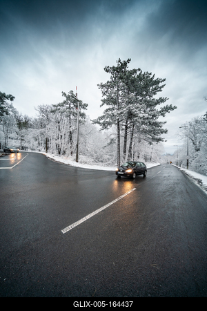 Snowy road with dramatic sky-stock-foto