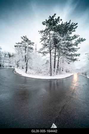 Snowy road with dramatic sky-stock-foto
