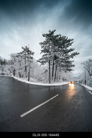 Snowy road with dramatic sky-stock-foto