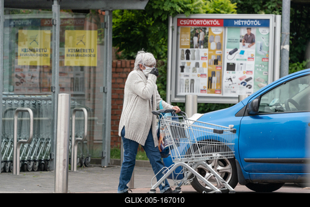 PECS - MAY 27 : Old woman go to shopping on the street  on 27 May 2020 in Pecs, Hungary. During coronavirus pandemic, everybody have to waering face mask-stock-foto