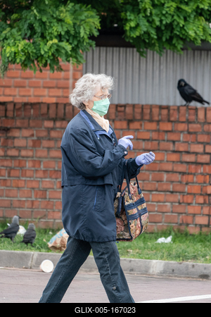 PECS - MAY 27 : Old woman go to shopping on the street  on 27 May 2020 in Pecs, Hungary. During coronavirus pandemic, everybody have to waering face mask-stock-foto
