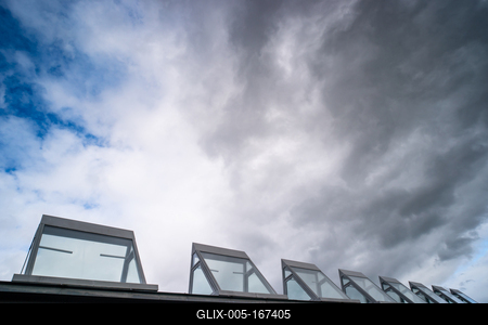 roof windows on a modern building  with cloudy sky-stock-foto