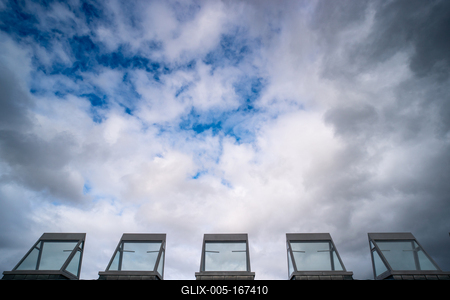 roof windows on a modern building  with cloudy sky-stock-foto