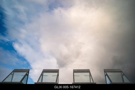 roof windows on a modern building  with cloudy sky-stock-foto