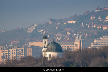 Small chapel in Pecs, Hungary with block houses-stock-foto