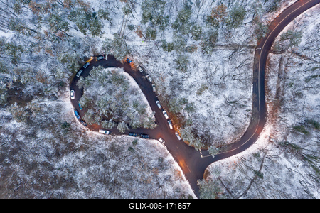 aerial view of curvy road with snowy forest-stock-foto
