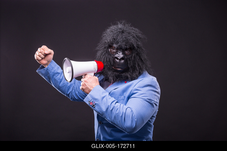 businessman wearing gorilla mask and screaming to megafon-stock-foto