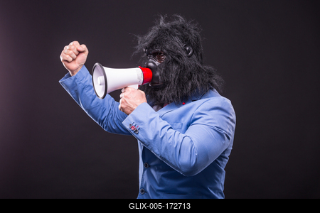 businessman wearing gorilla mask and screaming to megafon-stock-foto