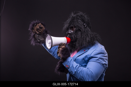 businessman wearing gorilla mask and screaming to megafon-stock-foto