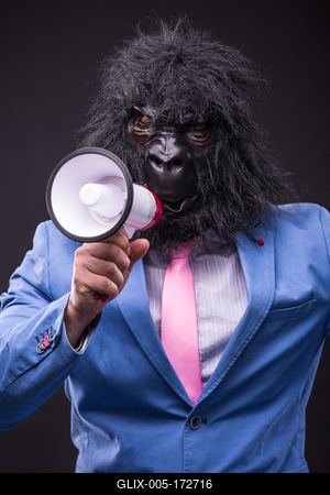 businessman wearing gorilla mask and screaming to megafon-stock-foto