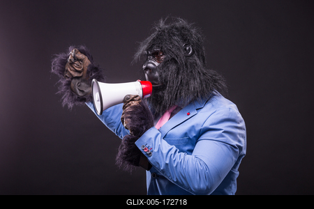 businessman wearing gorilla mask and screaming to megafon-stock-foto