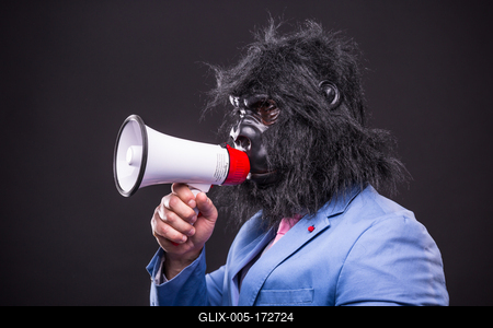 businessman wearing gorilla mask and screaming to megafon-stock-foto