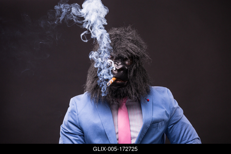 businessman wearing gorilla mask and smoking cigar-stock-foto