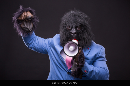 businessman wearing gorilla mask and screaming to megafon-stock-foto