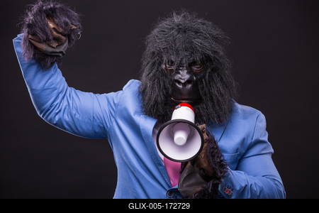 businessman wearing gorilla mask and screaming to megafon-stock-foto