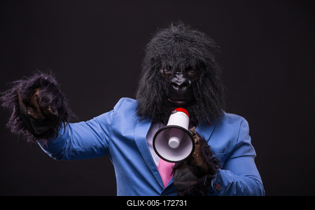 businessman wearing gorilla mask and screaming to megafon-stock-foto