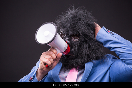 businessman wearing gorilla mask and screaming to megafon-stock-foto