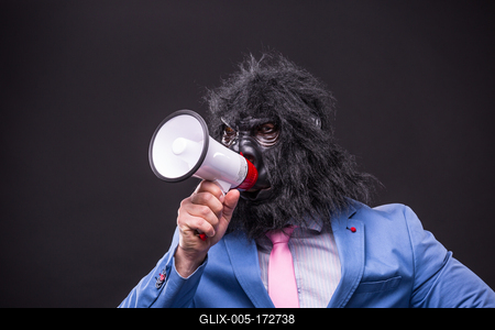 businessman wearing gorilla mask and screaming to megafon-stock-foto