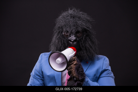 businessman wearing gorilla mask and screaming to megafon-stock-foto