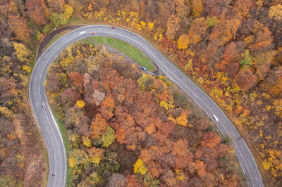 aerial view of Curvy road with autumn forest-stock-foto