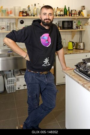 Igazi szatmári ember, fiatal szakálas férfi egy konyhában, Panyolán-stock-foto