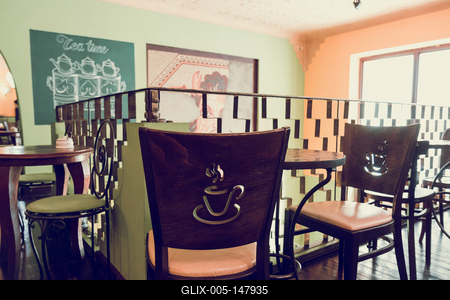 Teaház belső székekkel és asztalokkal, fali dekorációval-stock-foto