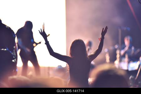 Crowd at a music concert, audience raising hands up-stock-foto