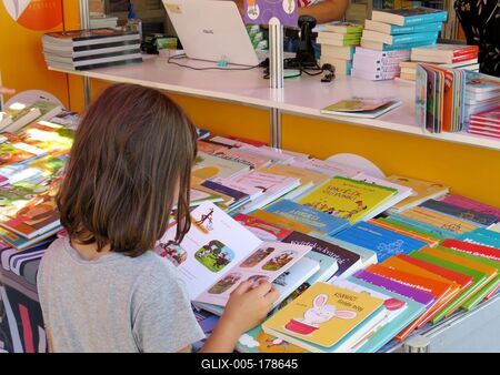 Little girl looking at a storybook at the Budapest International Book Festival-stock-foto