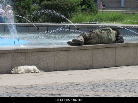 Bratislava (Pozsony), 19 May 2018Sleeping man and dog at a fountain.Alvó ember és kutya egy szökõkútnál.-stock-foto